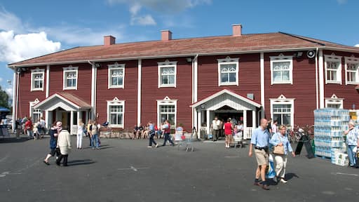 Tourists and the old-fashioned wooden house fake facade entrance to the Tuurin Kylakauppa shopping mall , Tuuri, Finland. Image shot 07/2004. Exact date unknown.