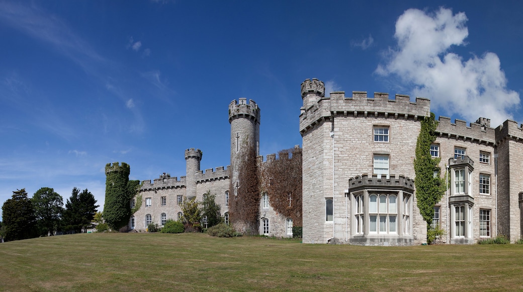 A large stone castle with multiple towers and ivy-covered walls.
