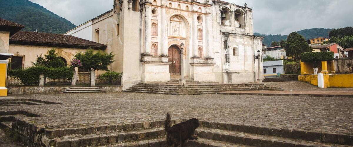 A historic church with a bell tower and steps leading up to it.