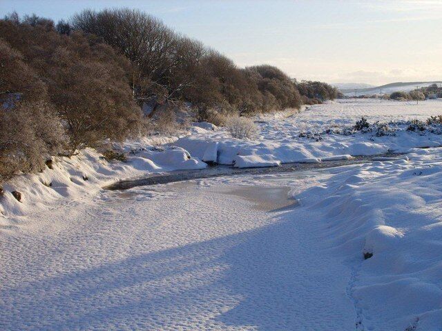 A frozen River Halladale View of the River Halladale immediately above (south) of the bridge which carries the road to Millburn/Trantlemore over it. The A897 road is obscured from view by the trees growing on the embankment seen at left.