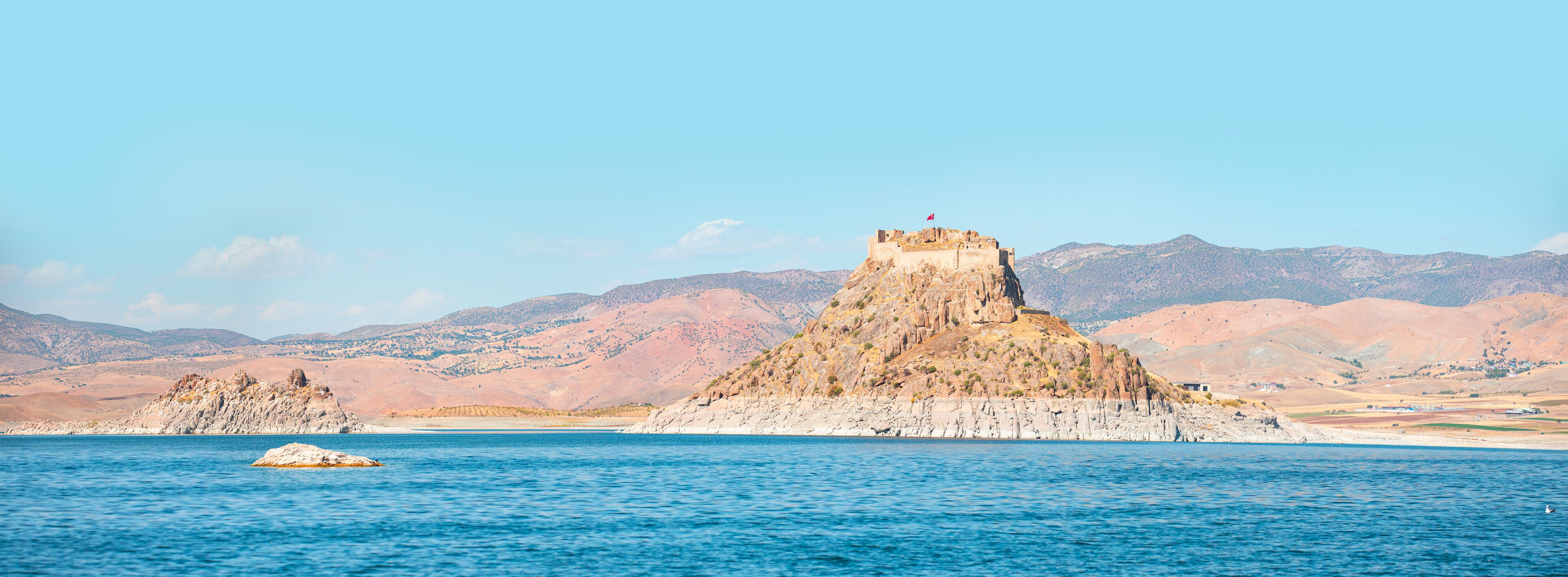 Pertek castle located in Pertek district of Tunceli - Pertek, Turkey Keban dam lake in the foreground