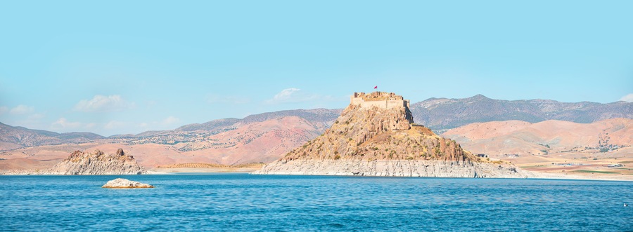 Pertek castle located in Pertek district of Tunceli - Pertek, Turkey Keban dam lake in the foreground