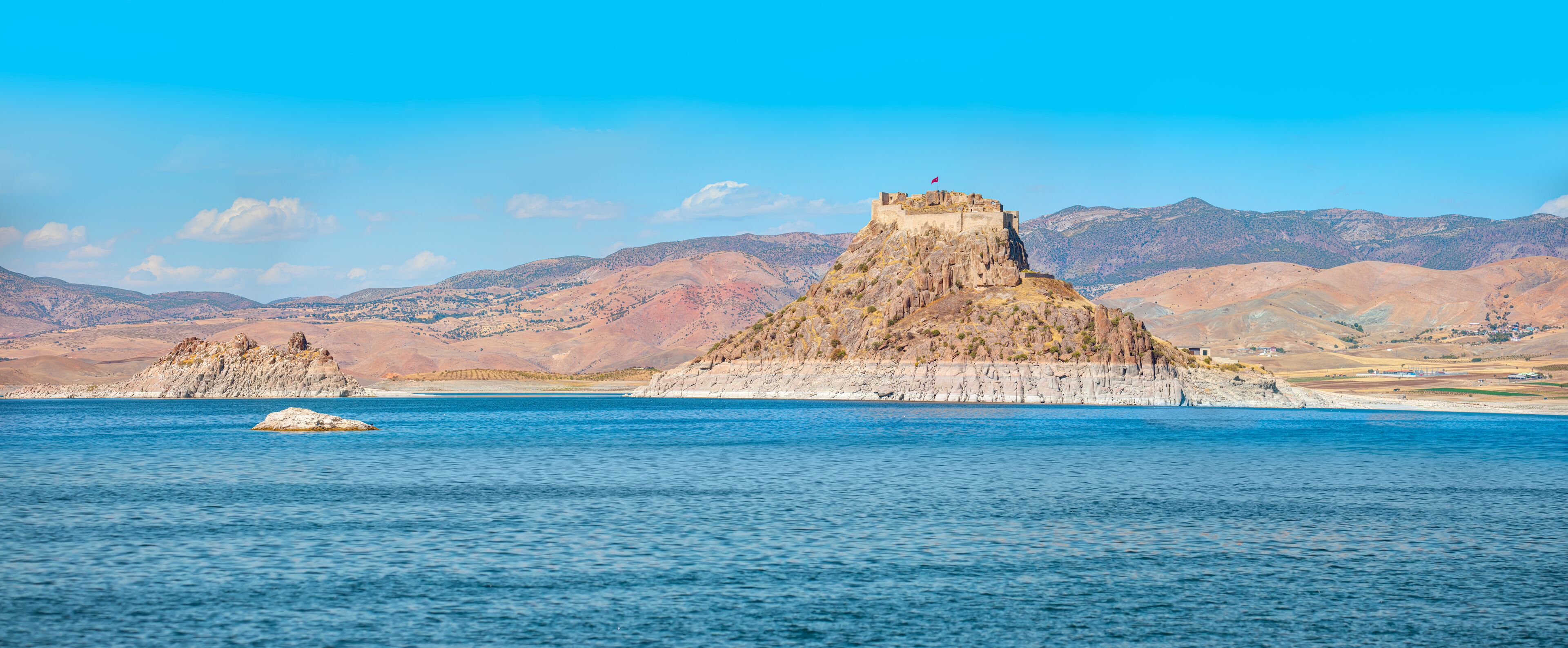 Pertek castle located in Pertek district of Tunceli - Pertek, Turkey Keban dam lake in the foreground