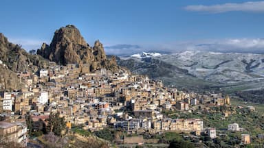 A mountainous town with dense buildings nestled against rocky cliffs.