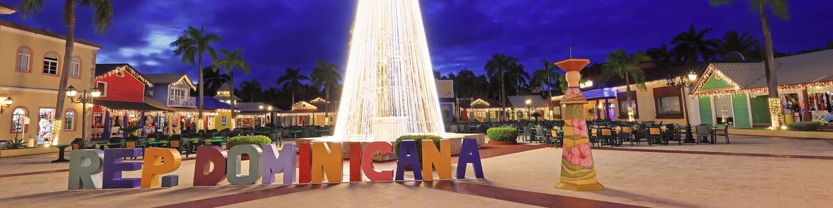 Beautiful illuminated Christmas Tree, Dominican Republic sign and shopping center square at dusk in Punta Cana