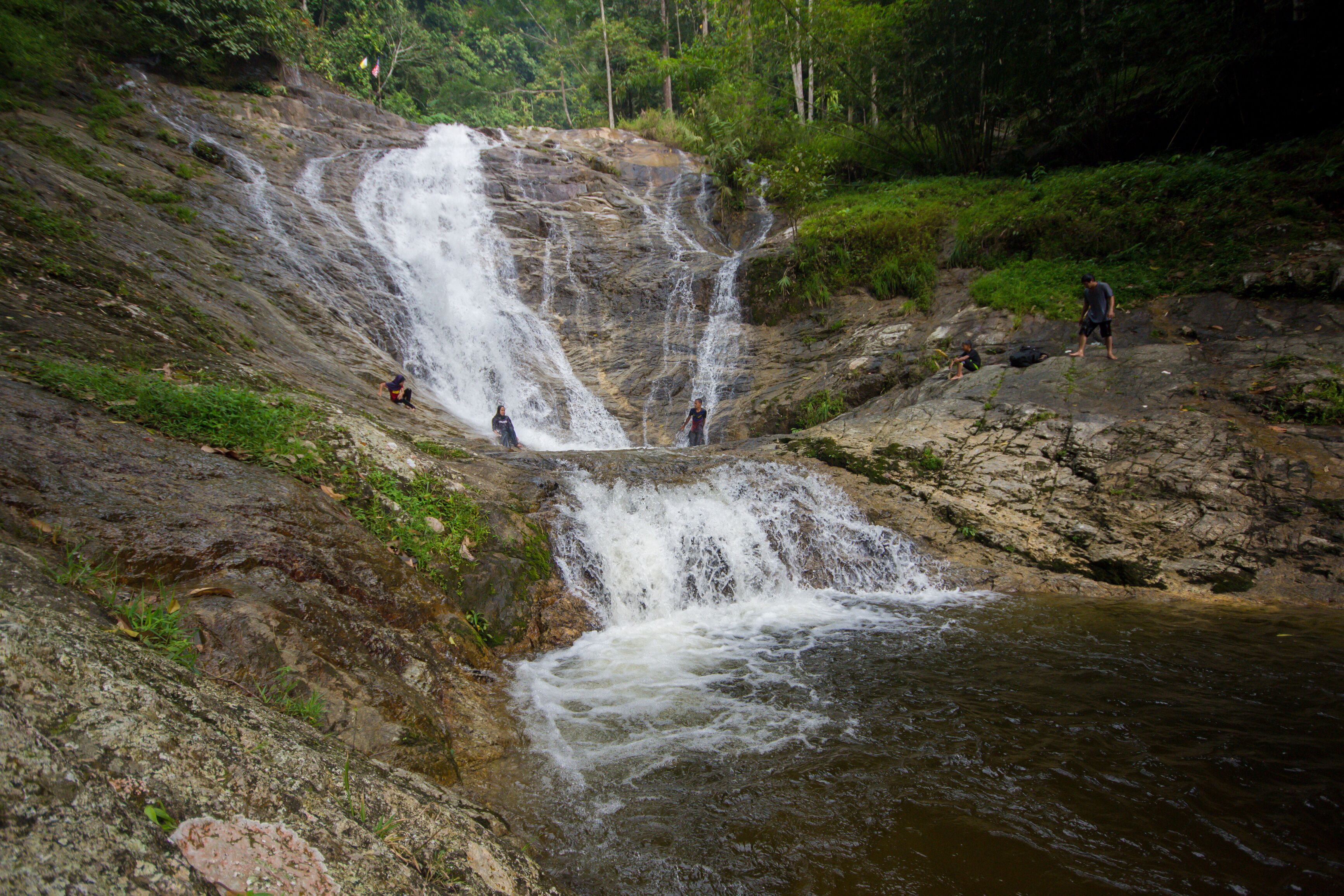 Lata Iskandar, Perak, Malaysia. March 25, 2018. A lady taking a rest at a Lata Iskandar waterfall, located along a trunk road from Tapah to Cameron Highland.