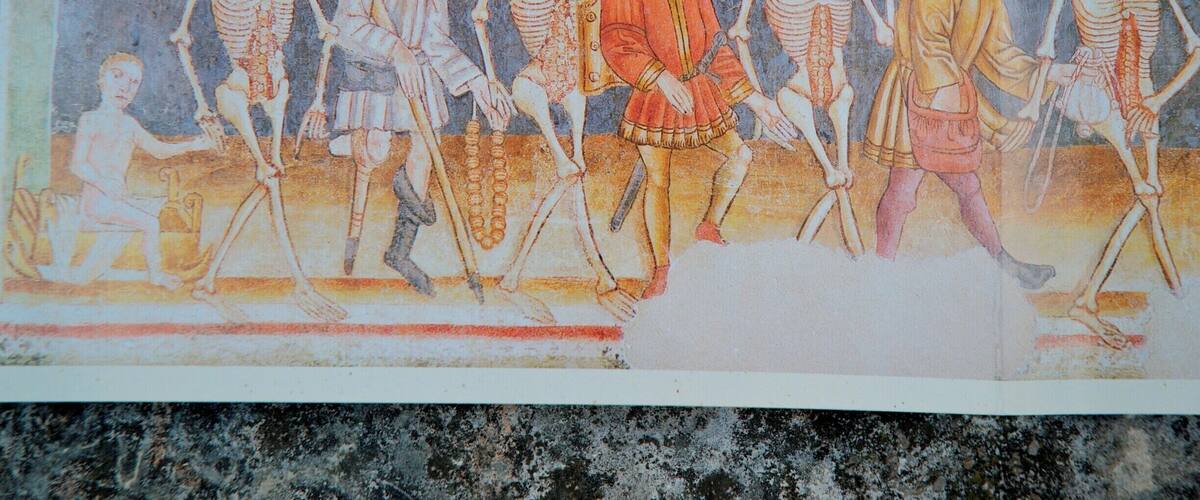 A historical illustration of skeletons and figures in period clothing.
