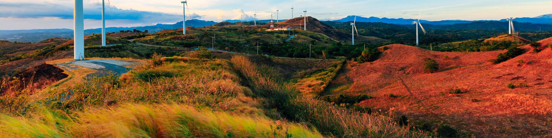 The Pililla Windmills harnessing clean energy during a golden sunset. It is a 54MW wind farm overlooking Laguna de Bay in Sitio Bugarin, Pililla Rizal, Philippines.