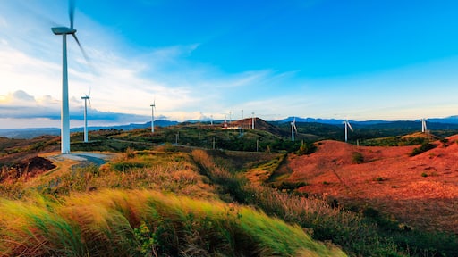 The Pililla Windmills harnessing clean energy during a golden sunset. It is a 54MW wind farm overlooking Laguna de Bay in Sitio Bugarin, Pililla Rizal, Philippines.