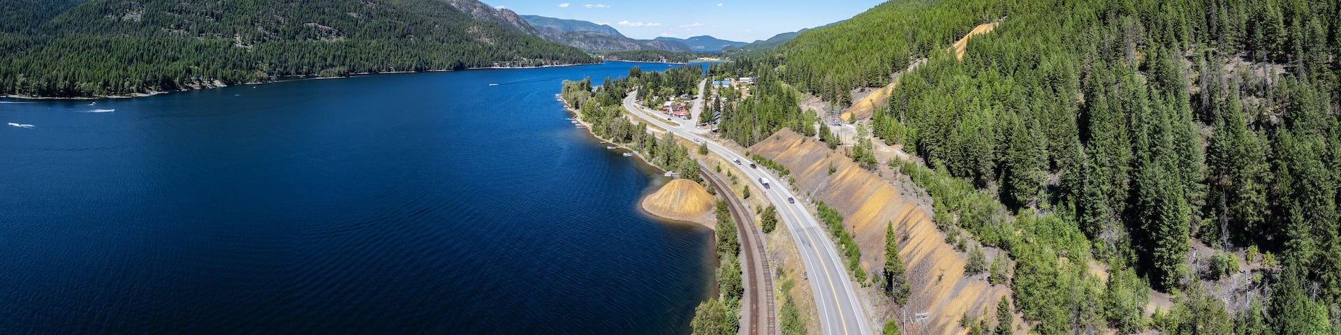 Aerial View of Highway by the lake and mountains. BC, Canada.