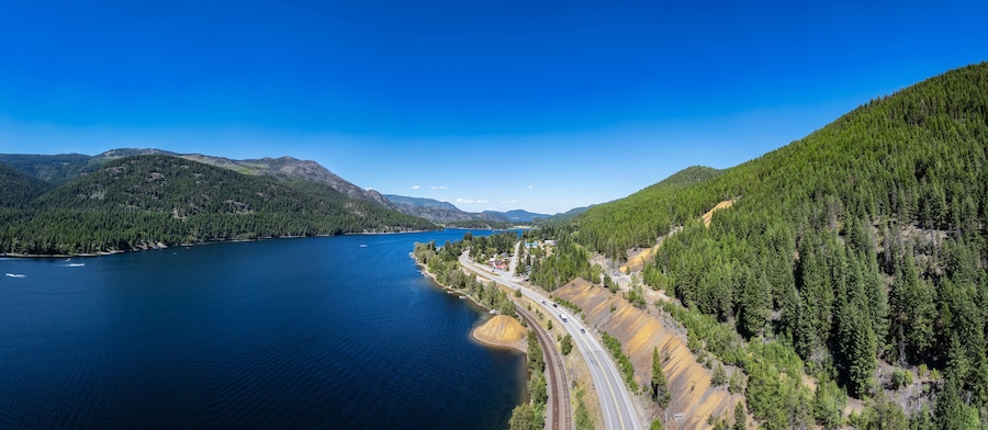 Aerial View of Highway by the lake and mountains. BC, Canada.