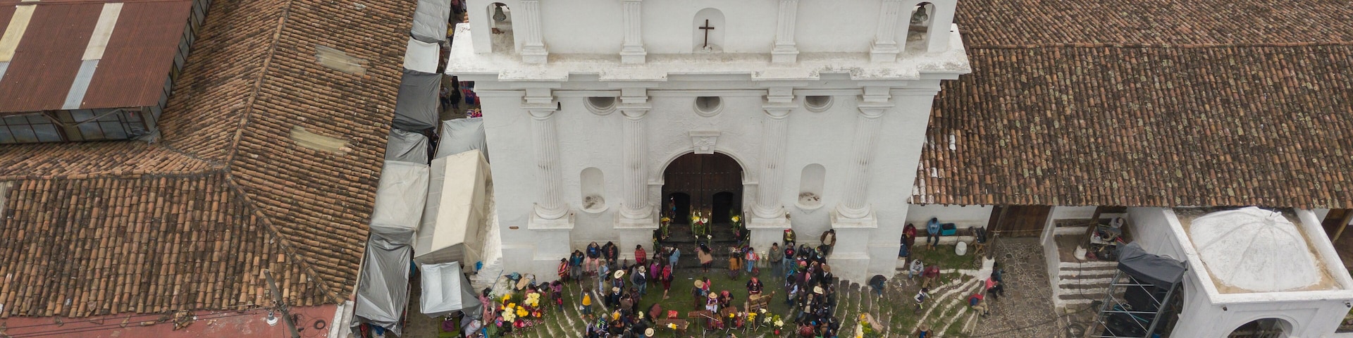 Aerial view of the church in Chichicastenango Guatemala with many people at the entrance.