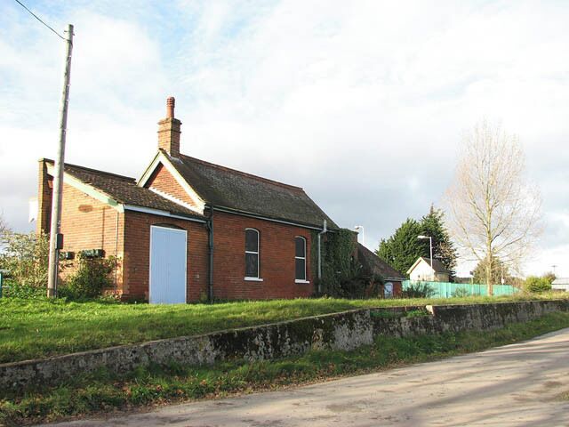 Worstead Station - the other side. A view of Worstead Station from the southeast. The road seen in the foreground provides parking and leads onwards to an industrial yard. For views of the other side of the station see > 1047345 and 1047372. The line connecting the city of Norwich with North Walsham was opened in 1874 and it reached the seaside town of Cromer by 1877. The rest of the line, between Cromer and Sheringham, opened in 1887. It is the remains of the Midland and Great Northern Joint Railway line (based in Melton Constable), part of which is preserved as a heritage railway, between the coastal town of Sheringham and Holt, further inland. Passenger services are operated by 'One Railway' which is part of the National Rail network, operated by National Express East Anglia and uses Class 150, Class 153, Class 156 or Class 170 diesel multiple units. The line is named after the Bittern (a member of the Heron family), a rare bird which can still be found in Norfolk's wetlands.