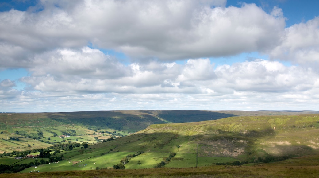 Rolling hills, a valley, and a partly cloudy sky.