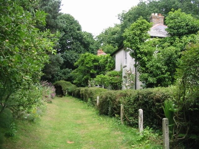 View along footpath from Fleming Road to Coombe Lane The footpath is well maintained in front of Ringlton Gate, the house on the right.
