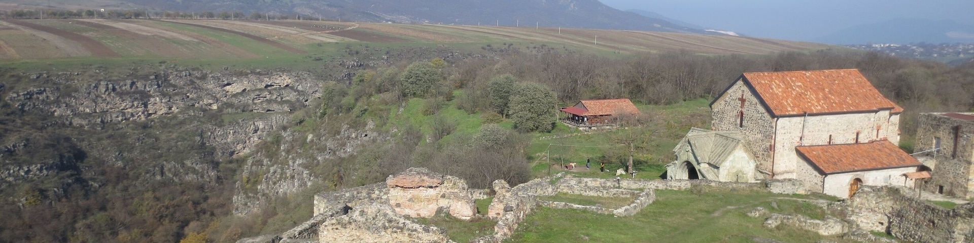 #localgem View from the Dmanisi area. Dmanisi is an archaeological site located in the southern Kvemo Kartli region of the country of Georgia.
This area was the site of a startling archaeological find some years ago - that find being the oldest evidence ever of humans outside of Africa. 5 sets of skulls were discovered here, all of them dating from nearly 1.8 million years ago.
Also located here (and visible in this picture) is the Dmanisi Sioni, a Georgian Orthodox church that dates from the 6th century.
This particular picture was taken from the top of an old fortress, looking towards the northeast. You can see a woman resting on the steps, towards the bottom of the picture.