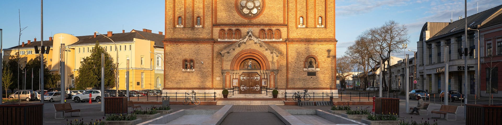 A historic church with two tall towers and a central clock.