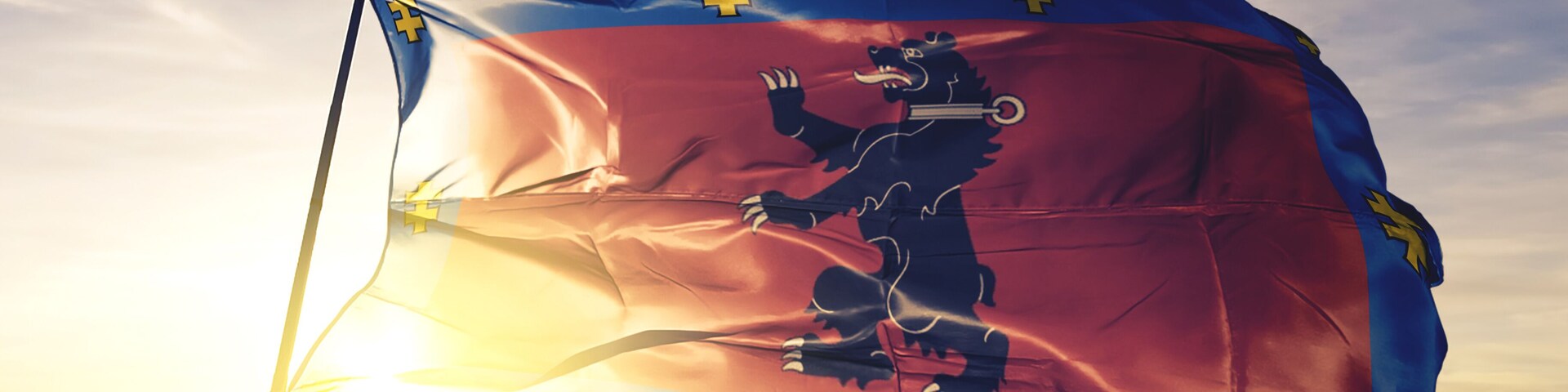 Telsiai county of Lithuania flag waving on the top sunrise mist fog