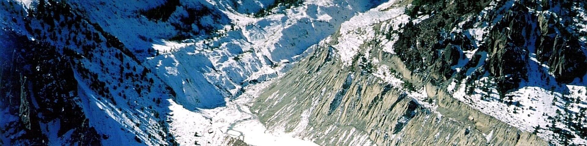 A mountainous landscape with a glacier and a small village.