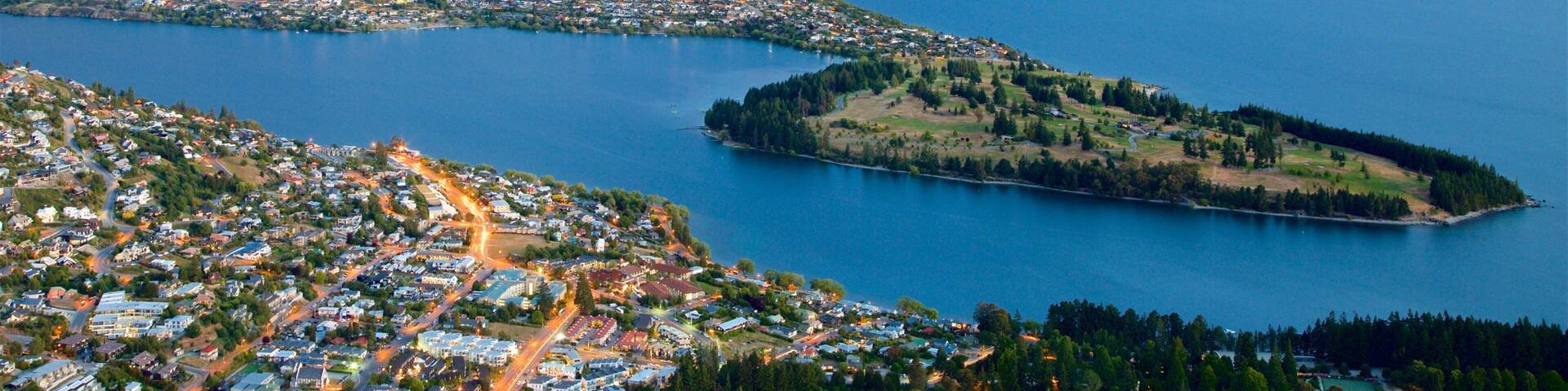 New Zealand featuring a sunset, a lake or waterhole and landscape views