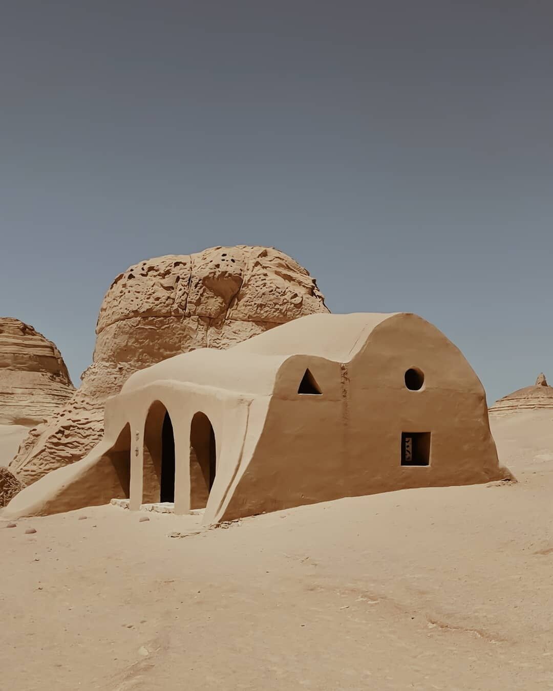 The #history:
The Valley of Whales was once submerged beneath the Terhys Sea. It is now home to an obscure museum which was built around the fossils of the prehistoric whale, Basilosaurus Isis. These fossils show the archaic species to have small hind legs; which supports the evolutionary notion that whales evolved from land based animals to sea dwelling creatures. 

What you see in this photo:
Most of the museum is open air but the rest of it is in these structures, designed to mimic their surrounding landscape. You can also see the beauty of the petrified coral on the ambient rock formations. 

Travel tips:
You can take a 4x4 tour to this National Park, the ride itself is part of the fun! At the museum make sure you explore the trail and then relax and have tea and snacks in their cafe.
Afterwards, have a BBQ with the locals, go sand surfing, see the Magic Lake and go horse riding as the sun sets! It is a very doable day trip from Cairo, and an unforgettable one for sure.