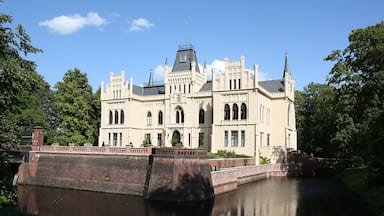 A large, ornate building with a canal in front.