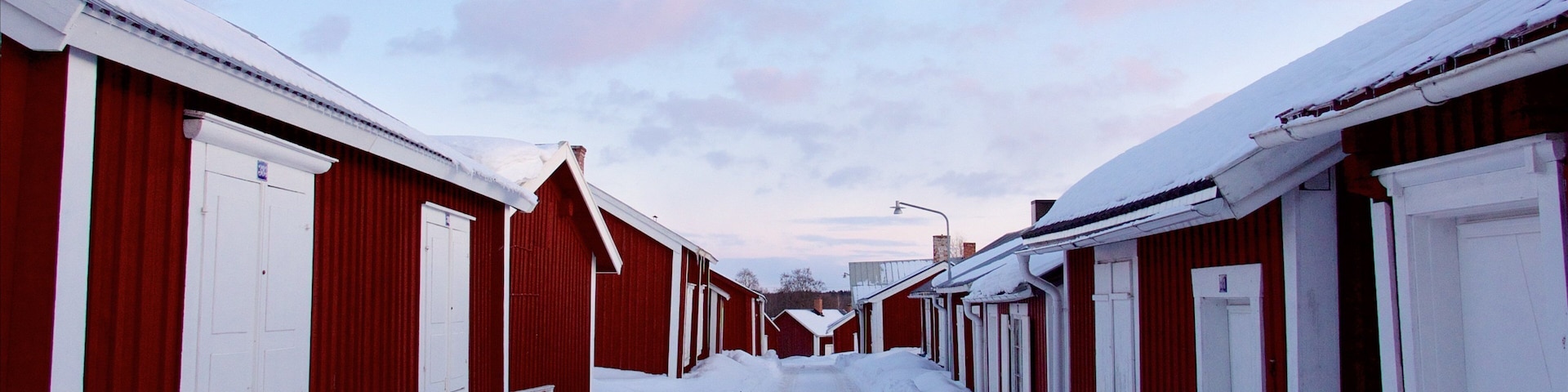 Gammelstad featuring snow, a small town or village and a sunset