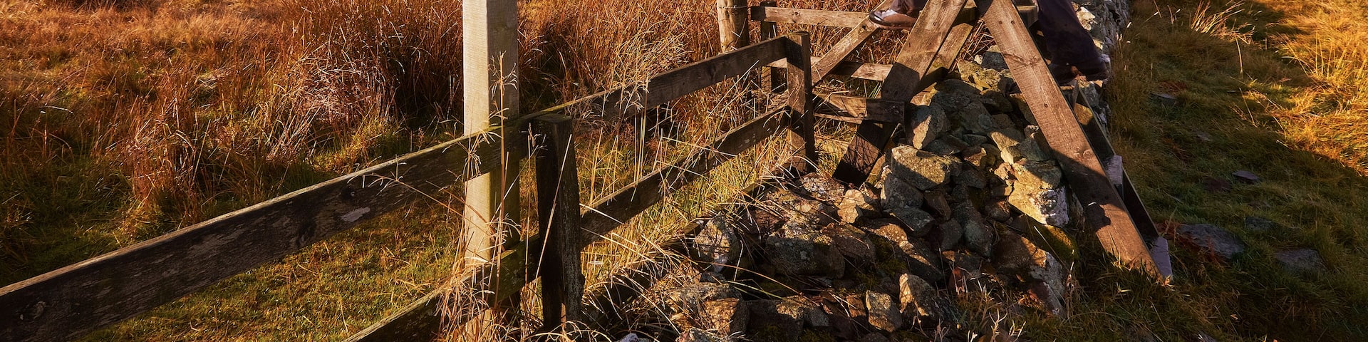 A woman crossing a stile on the Pennine Way, English Countryside walk.UK; Shutterstock ID 275558420; Purchase Order: -