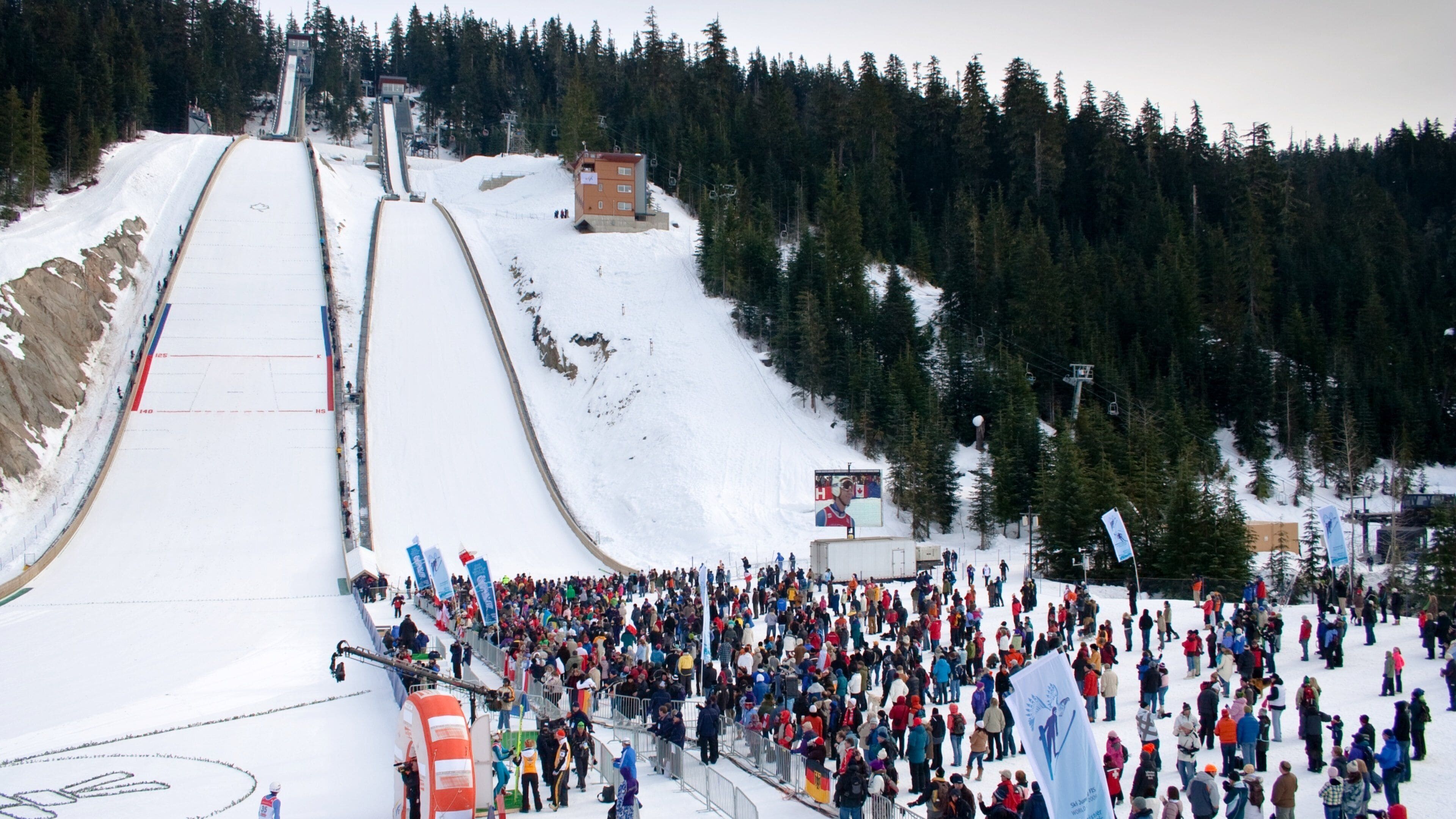 Sea to Sky Highway showing snow and mountains as well as a large group of people