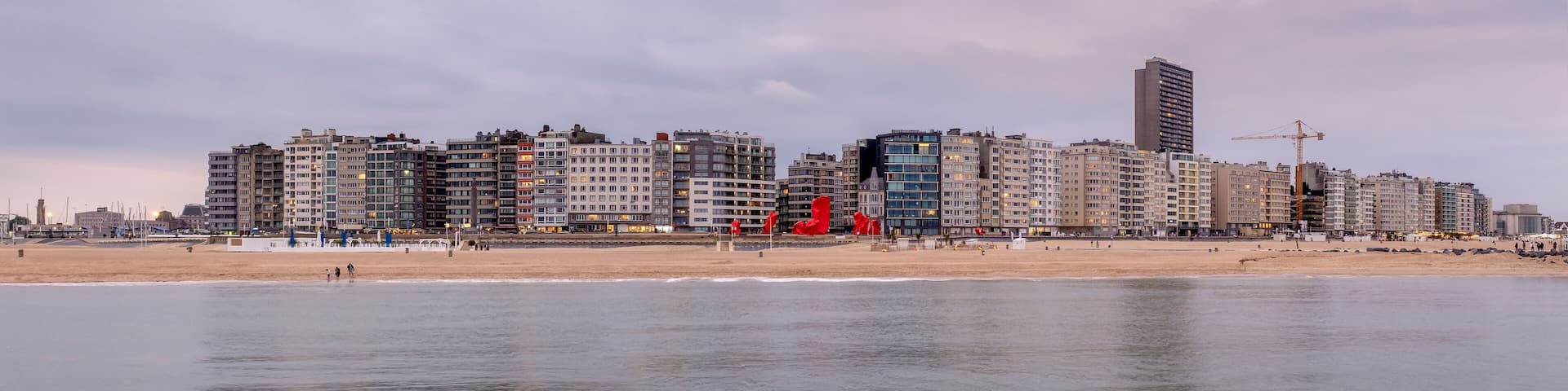 Skyline of Ostend (Belgium) against cloudy sky after sunset.