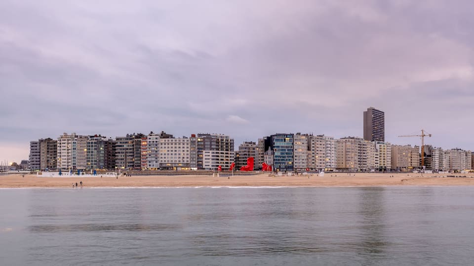 Skyline of Ostend (Belgium) against cloudy sky after sunset.