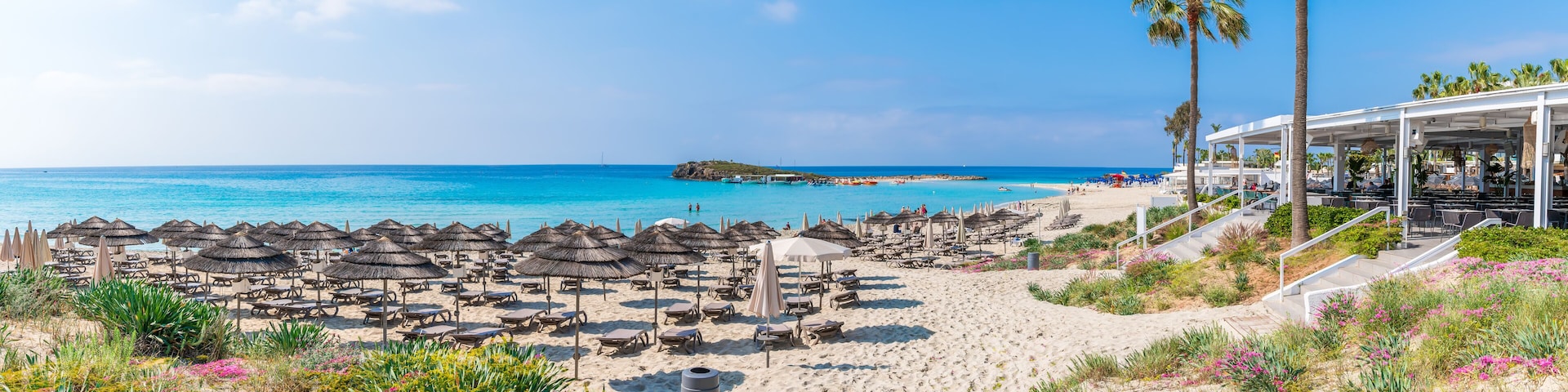 Discover the pristine Nissi Beach in Cyprus, a paradise with white sands and turquoise waters, perfect for relaxation, water sports, and family holidays