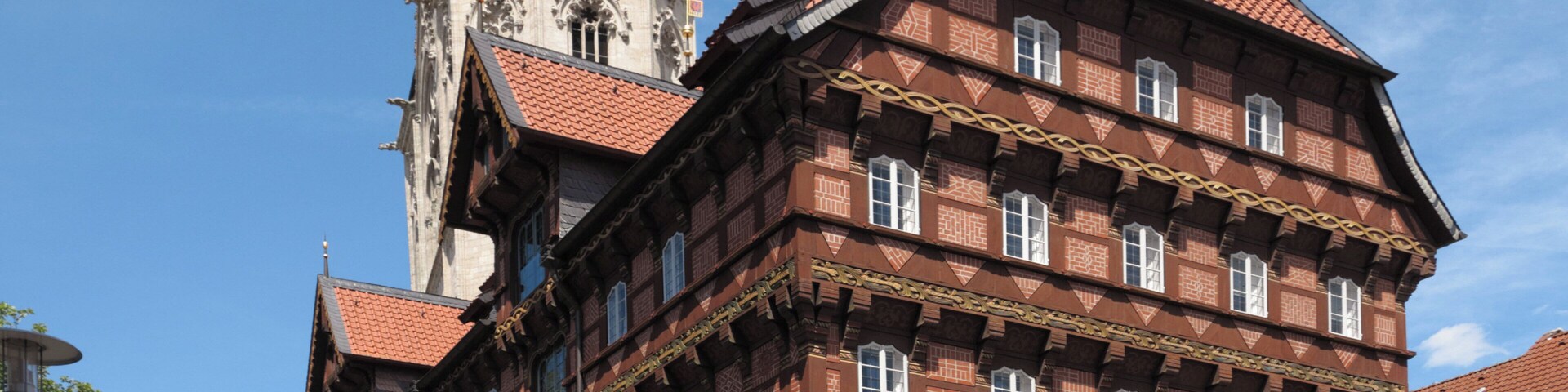 The Old Scale (Alte Waage) in Brunswick, Germany. It was constructed in 1534, destroyed in World War II and reconstructed in 1994. In the background: the south tower of the Church of St. Andrew.