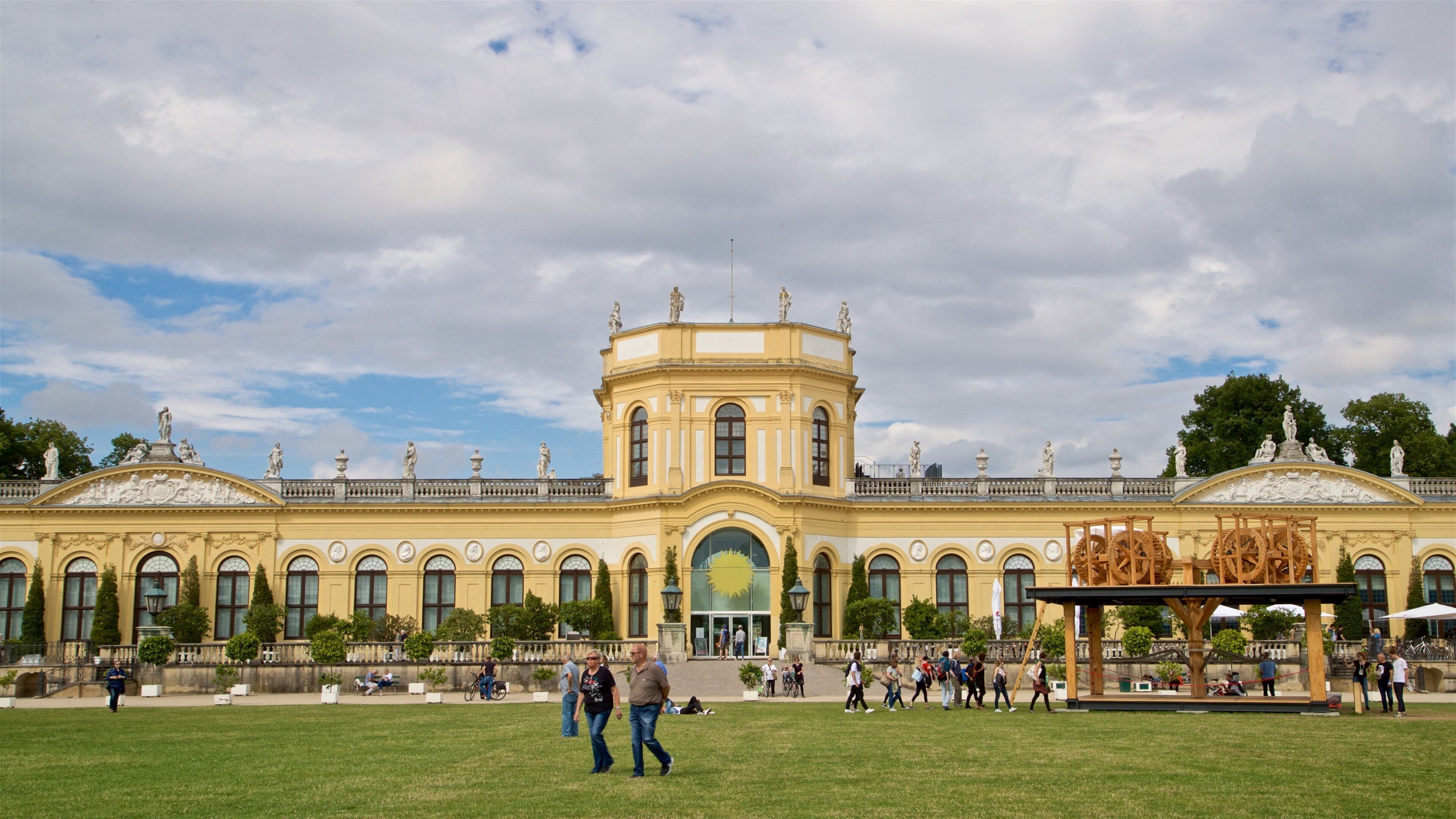 A large, ornate building with a central dome and statues on the roof.