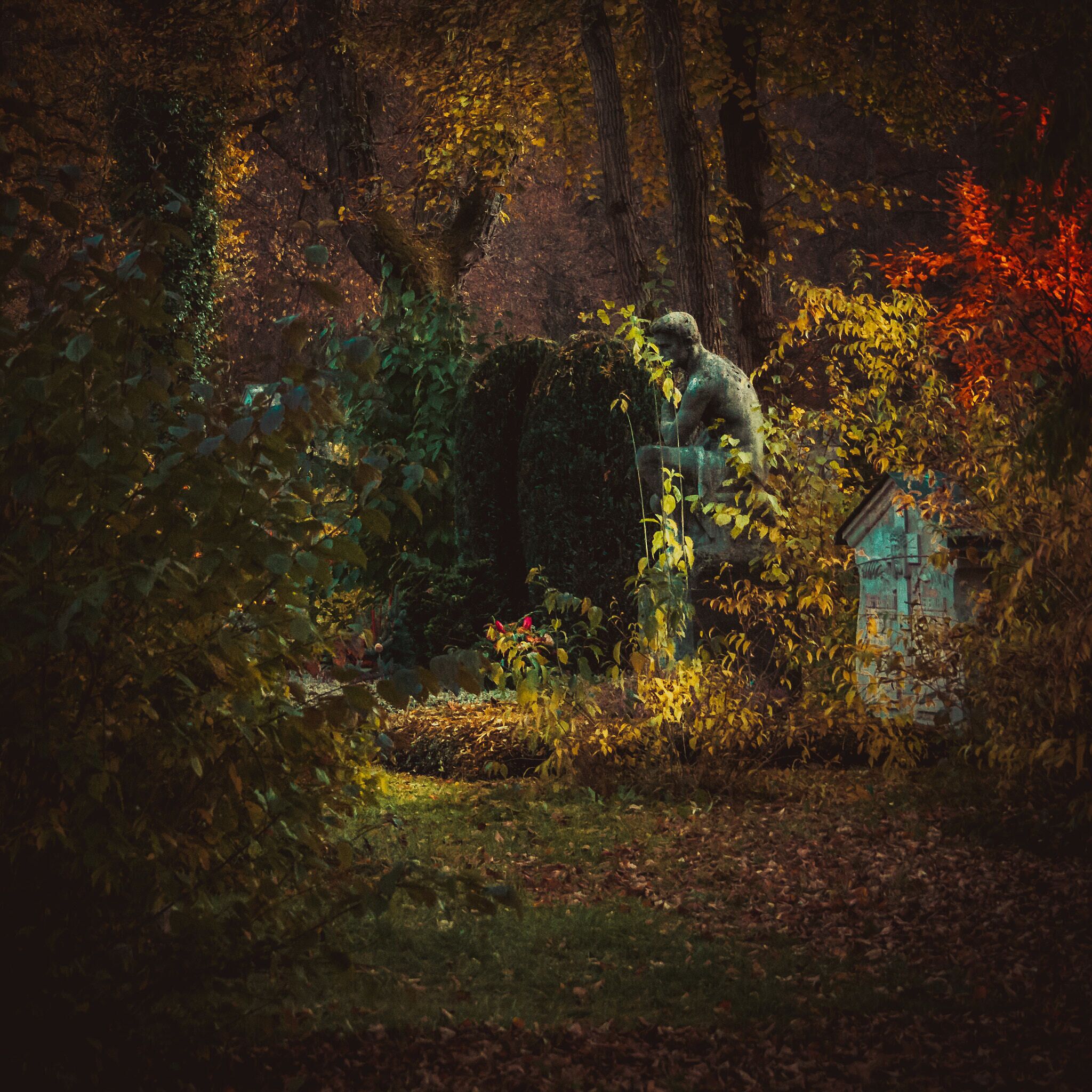 500px provided description: The Thinker as a tombstone in a Munich cemetery. Symbol for the melancholy memory of the past. (Nostalgic picture in Pre-Raphaelite style) [#cemetery ,#tombstone ,#memory ,#nostalgia ,#The Thinker]