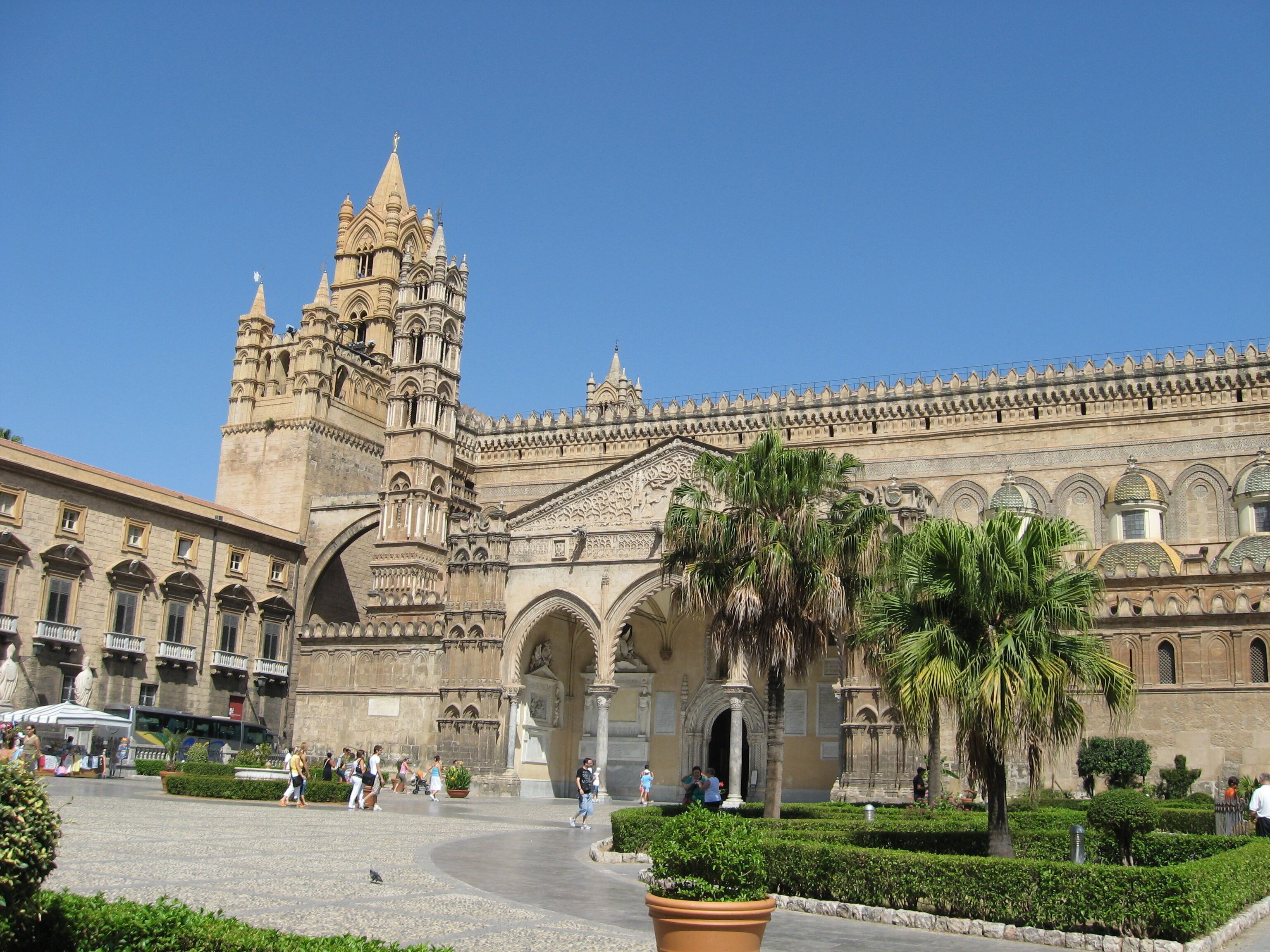 A historic building with intricate architecture, including a tower and arches.