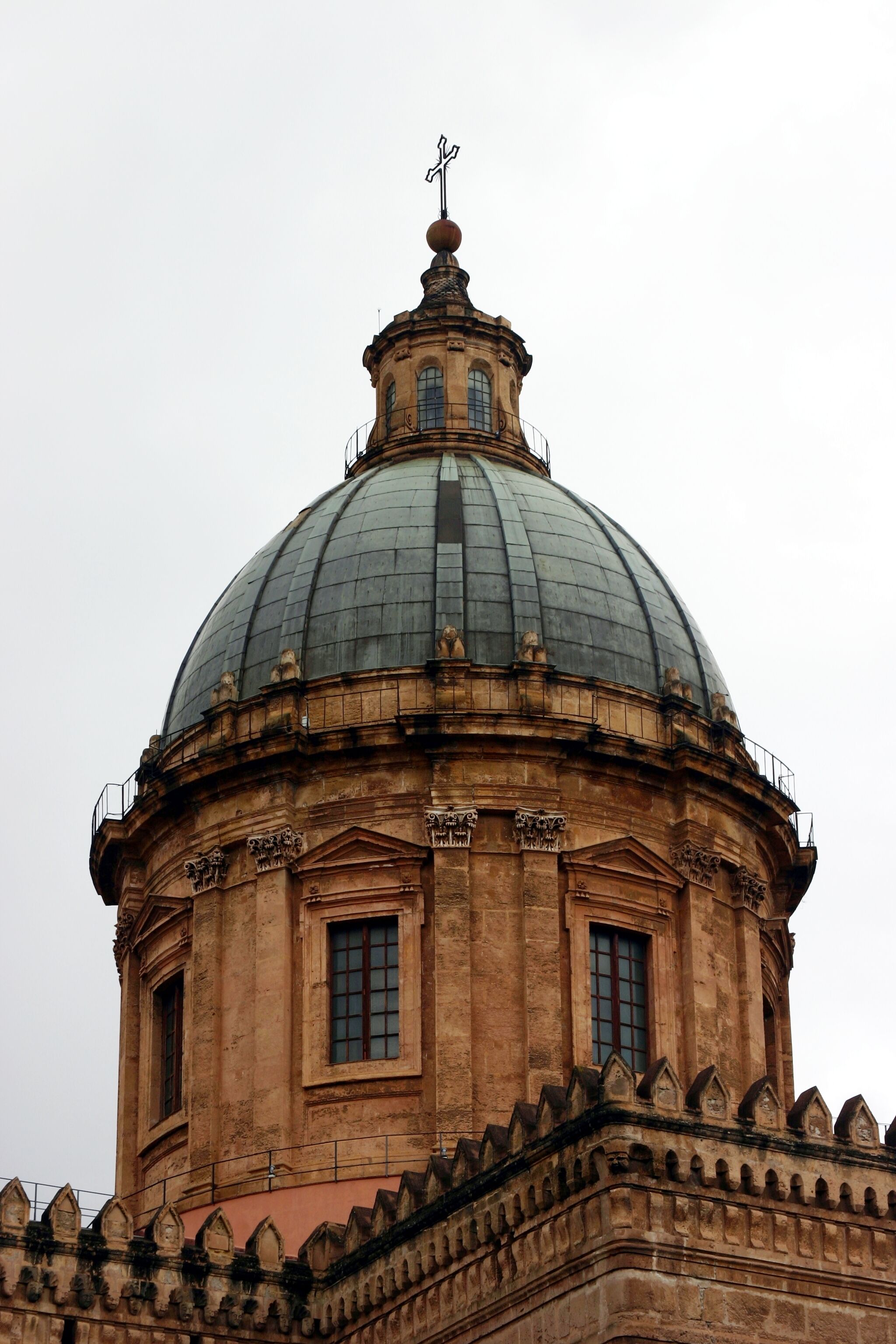 A large domed building with a cross on top, featuring arched windows and intricate stonework.