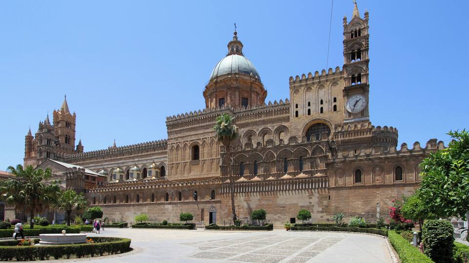 A historic building with a large dome, clock tower, and intricate architecture.