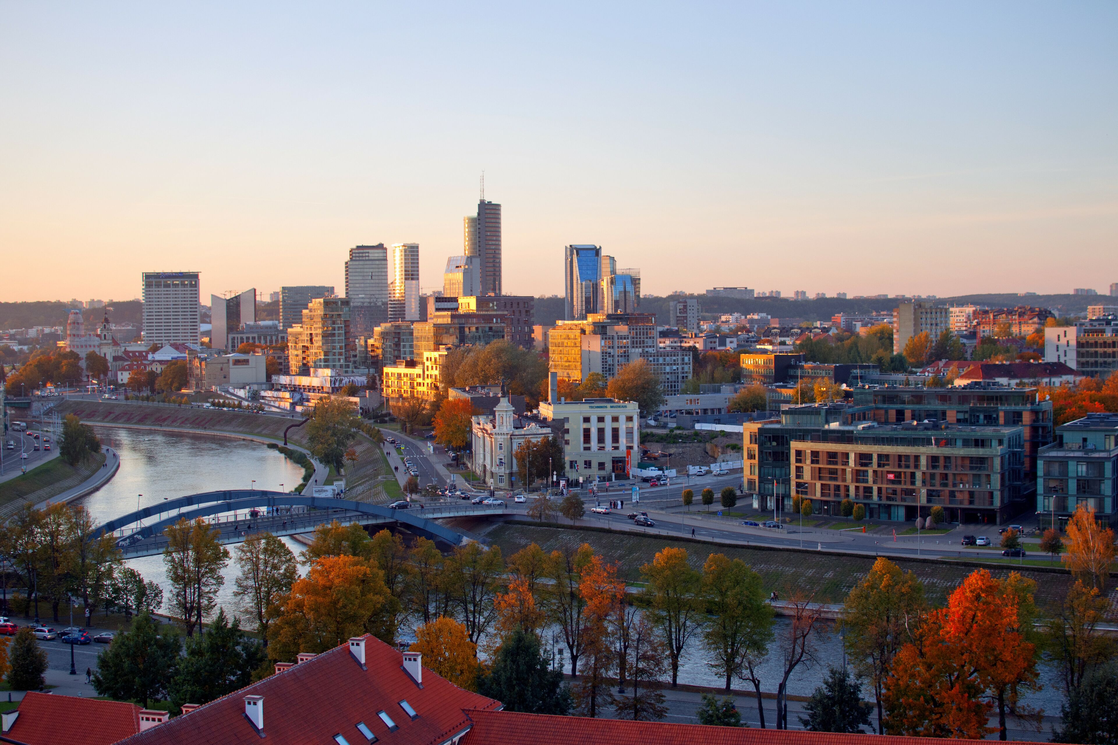 Cityscape view to new town ("Naujamiestis") with modern buildings at another side of Neris river during the sunset at autumn evening.