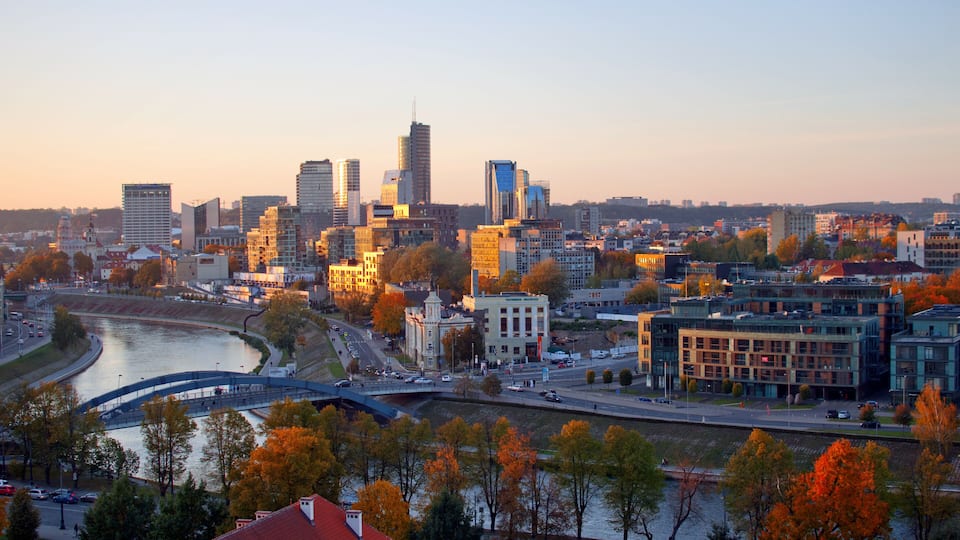 Cityscape view to new town ("Naujamiestis") with modern buildings at another side of Neris river during the sunset at autumn evening.