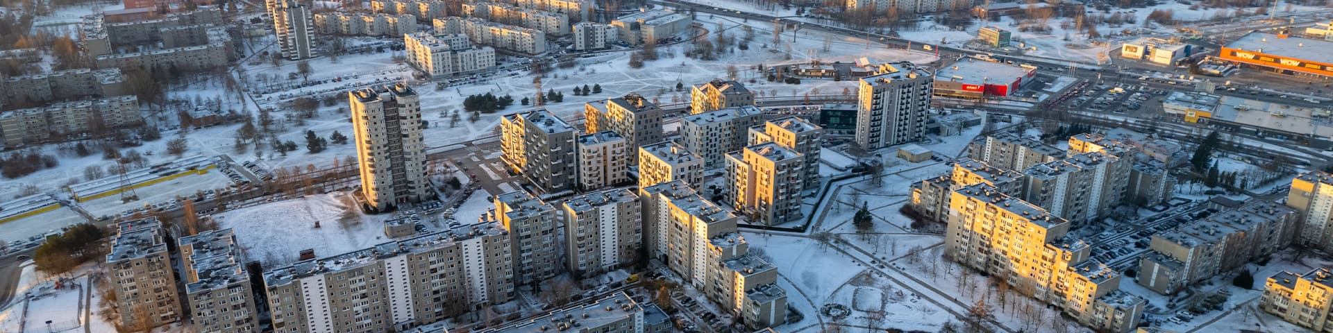 A cityscape with numerous high-rise buildings, roads, and a large industrial complex.