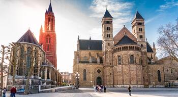 A historic church with two prominent towers and a red bell tower.