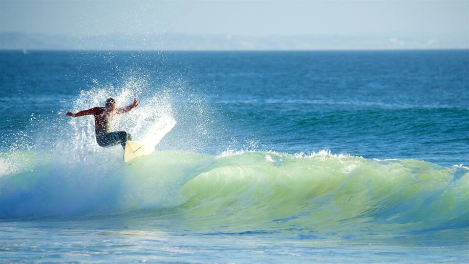 A surfer riding a wave in the ocean.