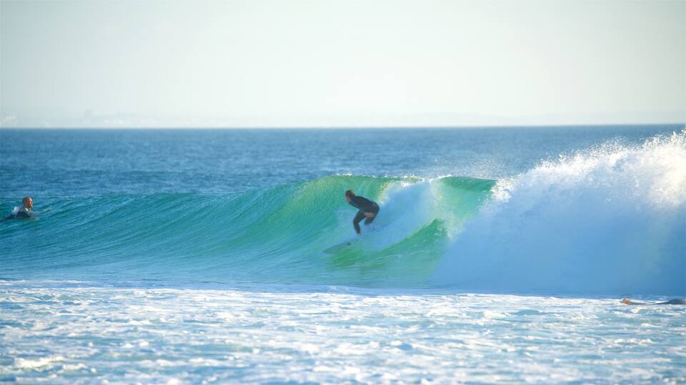 A surfer riding a large wave in the ocean.