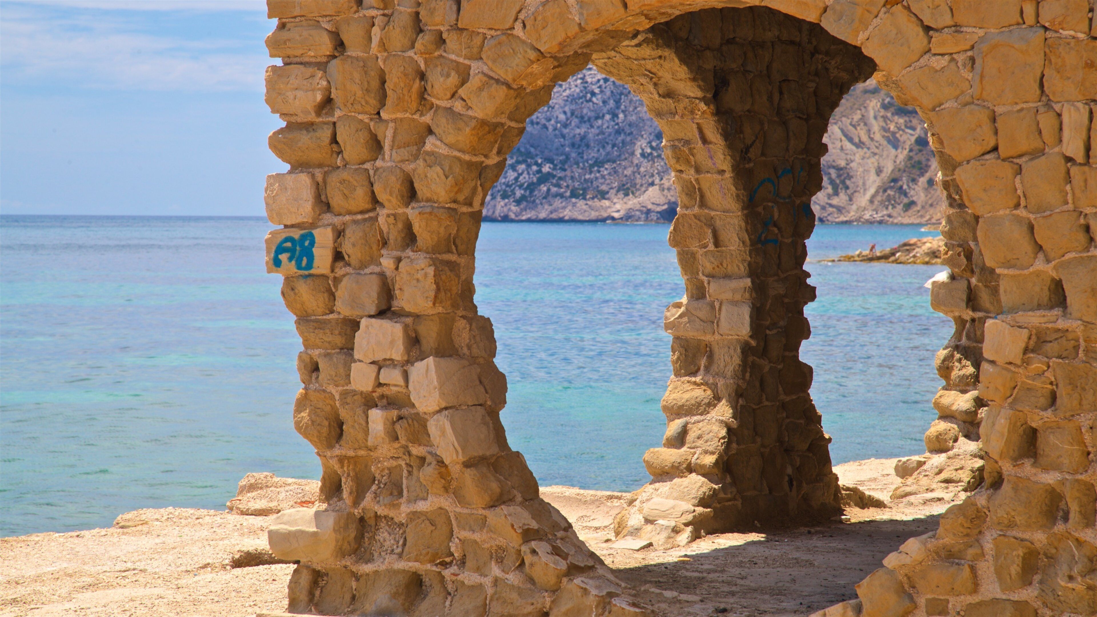 Cala La Manzanera which includes general coastal views and heritage elements