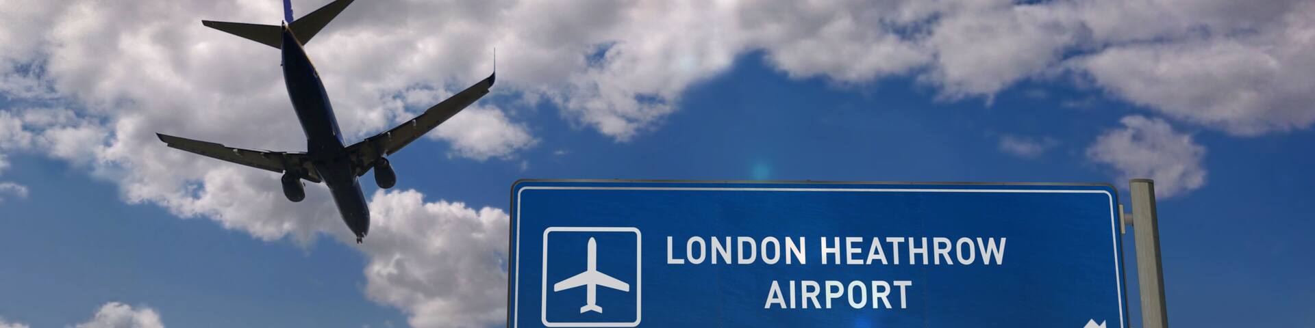 Plane landing in London Heathrow with signboard