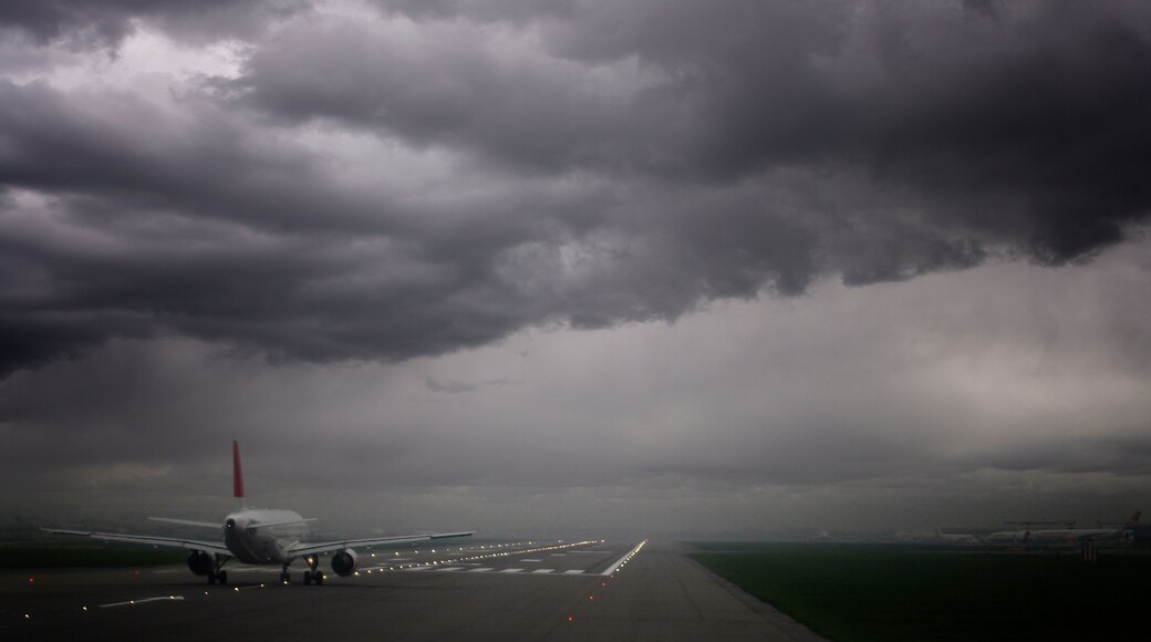Plane ready for take off and stormy skies, Heathrow Airport, London