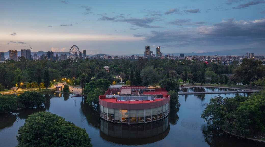 Aerial view of Chapultepec Lake surrounded by urban architecture and greenery at dusk, Miguel Hidalgo, Mexico City, Mexico.
