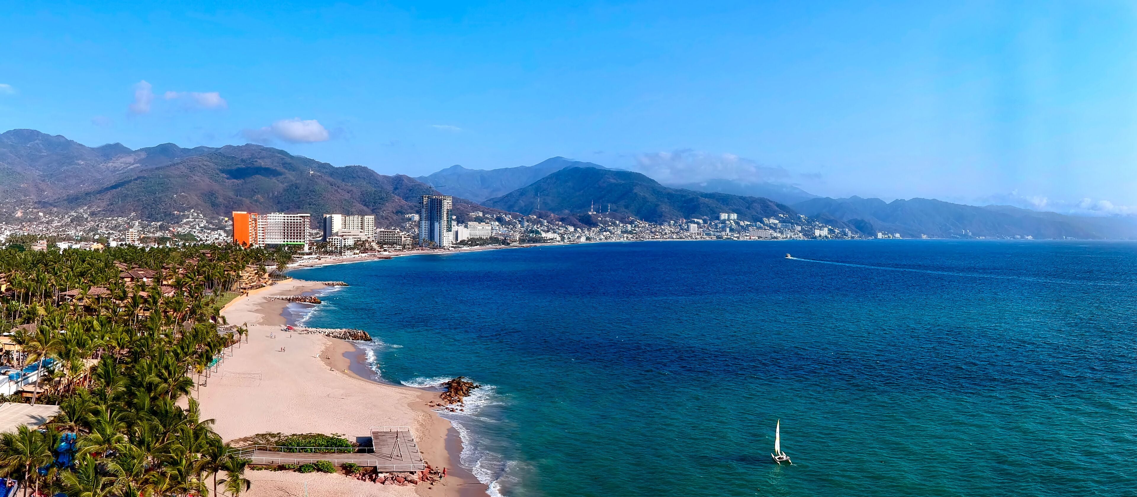 Aerial view of beach with a city in the background