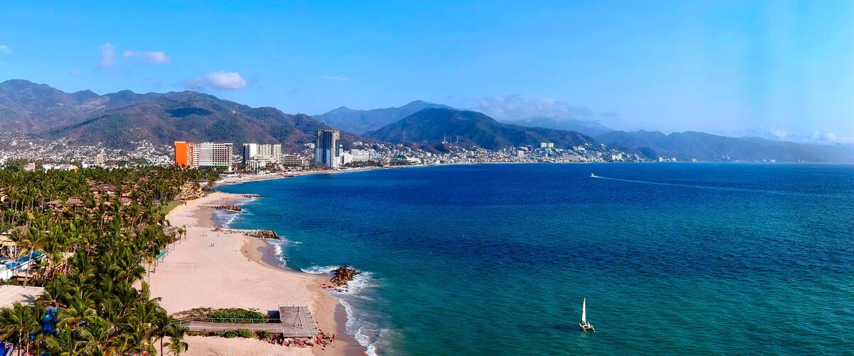 Aerial view of beach with a city in the background
